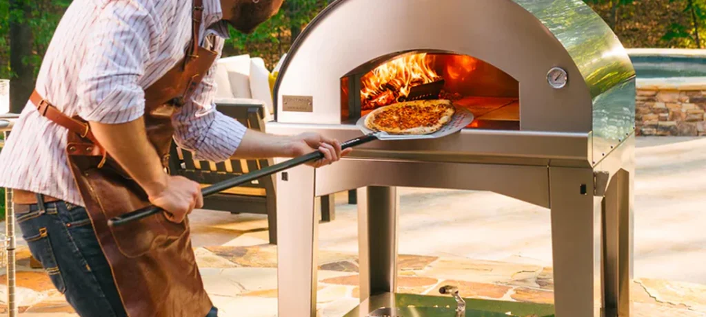 Cooking pizza in a lit Fontana wood-fired oven on an outdoor terrace